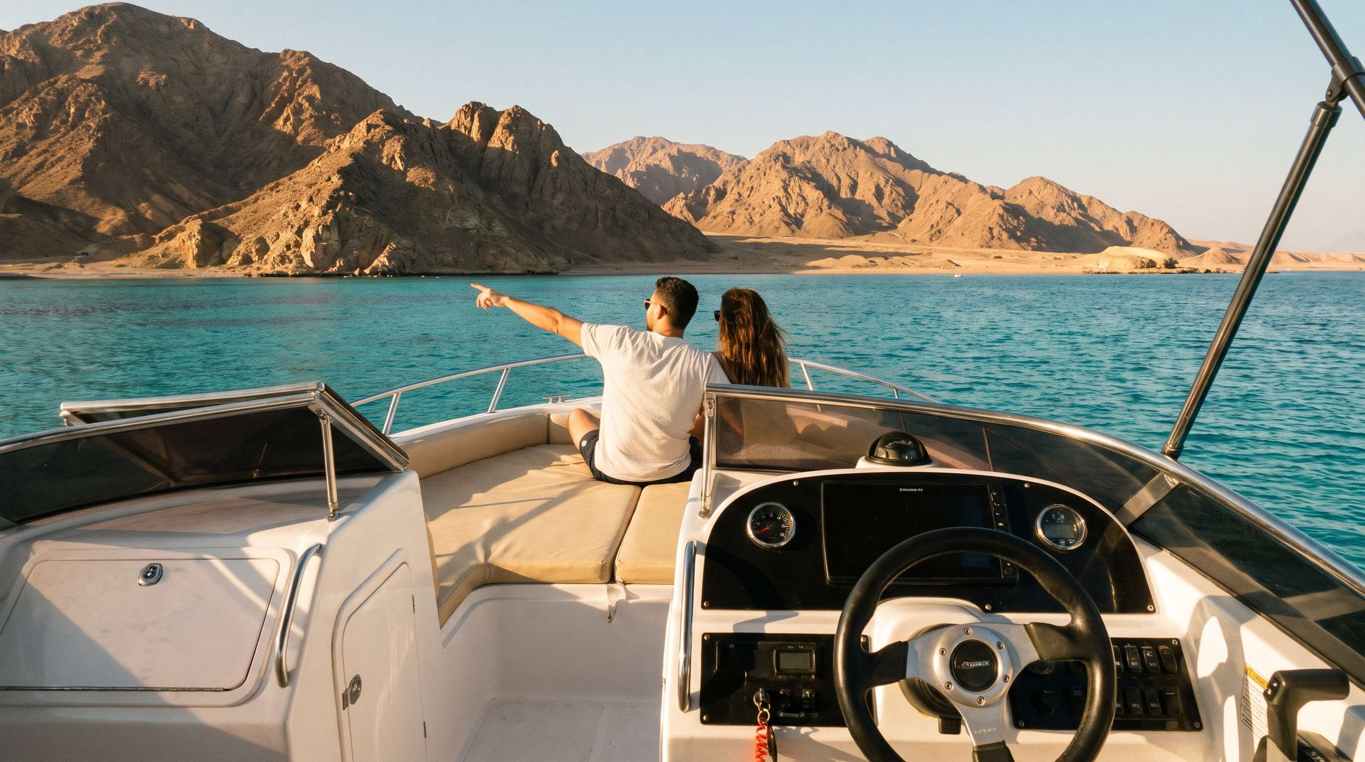 Couple on a private speedboat pointing at the Sinai mountains