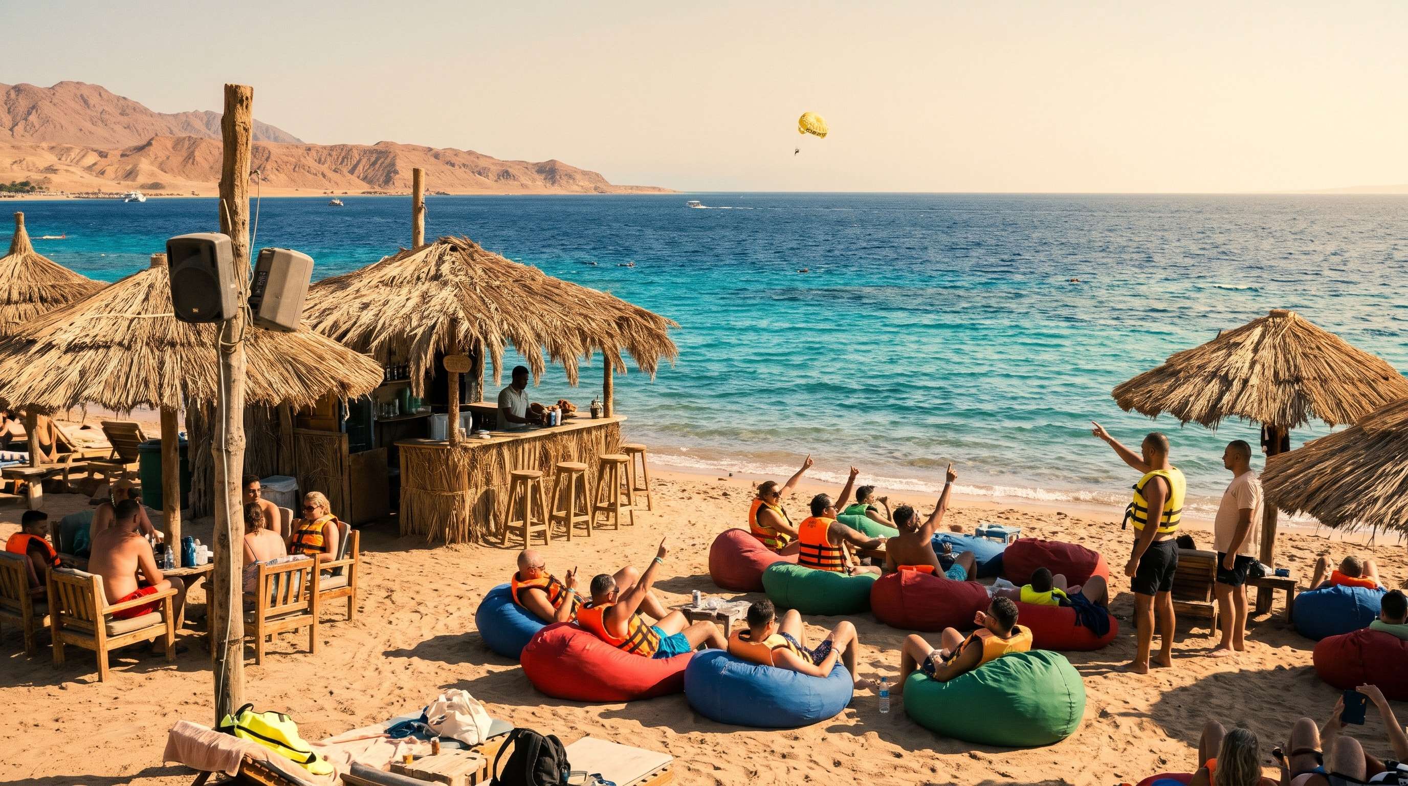 Guests relaxing on colourful bean bags at the beach bar at Sharm El Maya